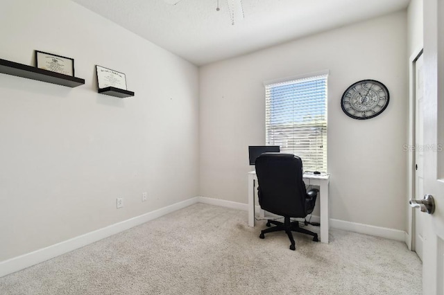 carpeted home office with baseboards