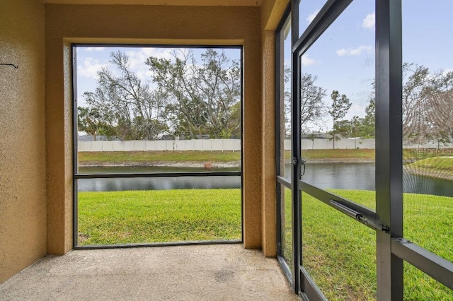 unfurnished sunroom with a water view