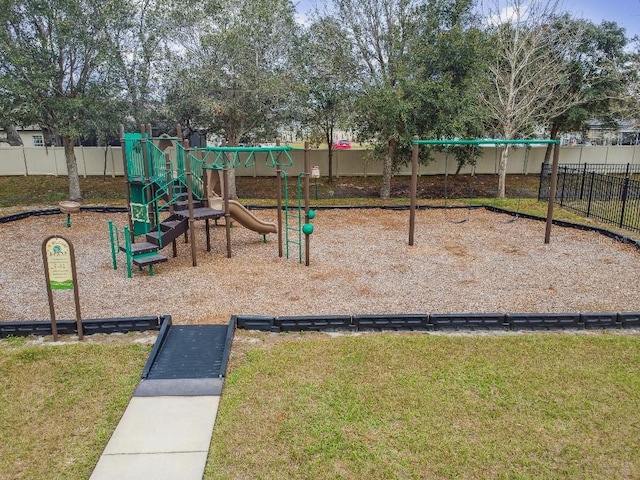 community play area featuring a lawn and fence