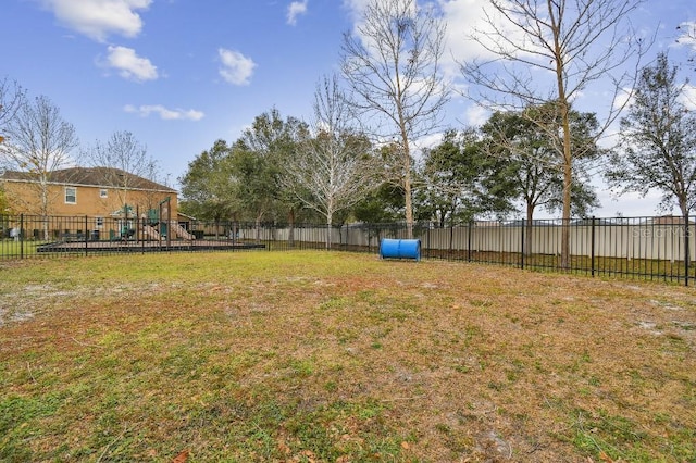 view of yard with a playground and fence