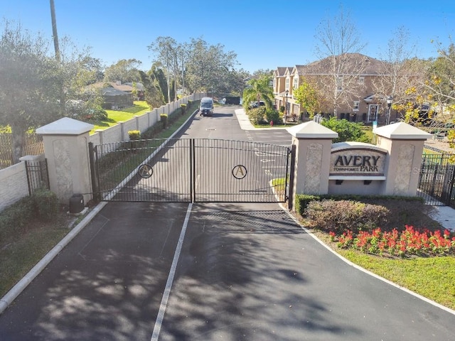 view of road featuring a gate, a residential view, and a gated entry