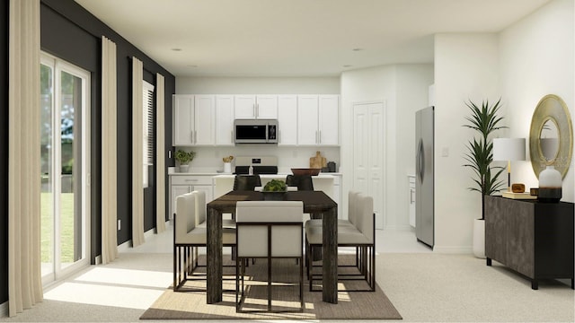 kitchen featuring white cabinetry, light countertops, appliances with stainless steel finishes, and light carpet