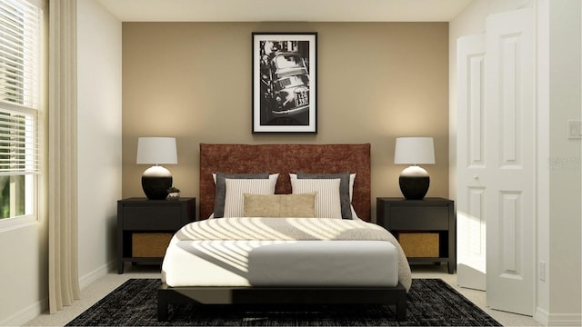 bedroom featuring light colored carpet and baseboards