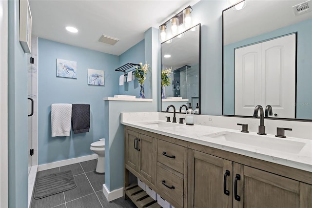 bathroom featuring a sink, visible vents, and toilet