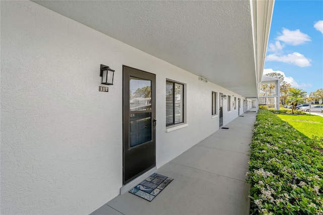 entrance to property with stucco siding