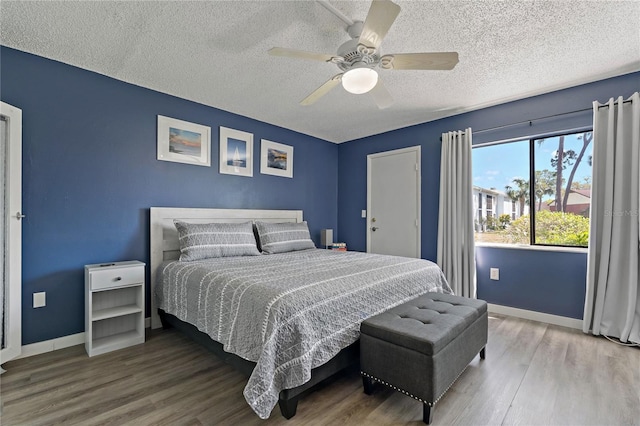 bedroom featuring wood finished floors, baseboards, and ceiling fan