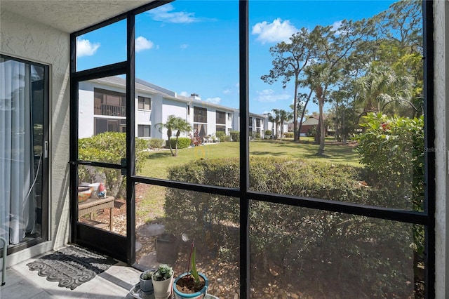 unfurnished sunroom featuring a residential view