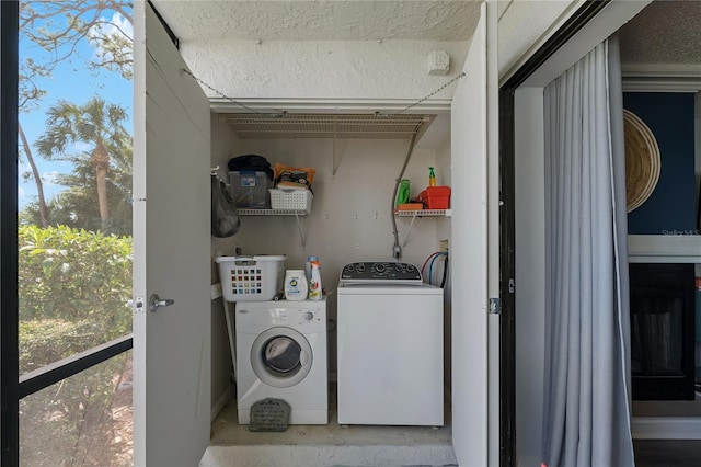 laundry room with laundry area, independent washer and dryer, and a textured ceiling