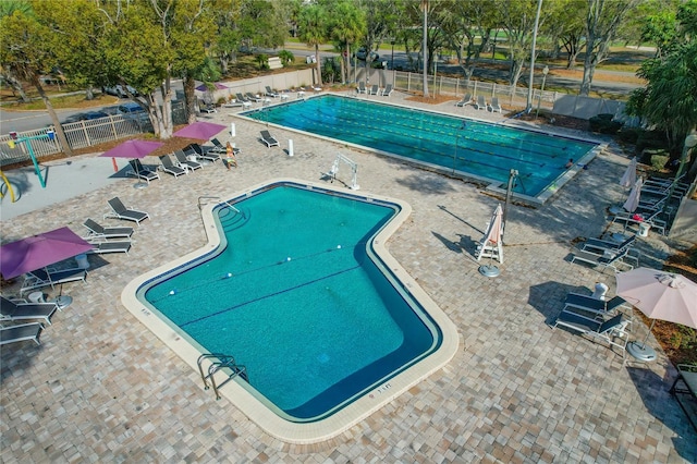 pool featuring a patio area and fence