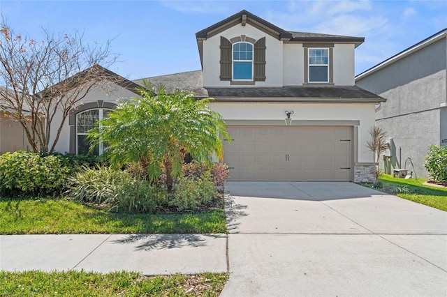 view of front of home featuring stucco siding, driveway, and a garage