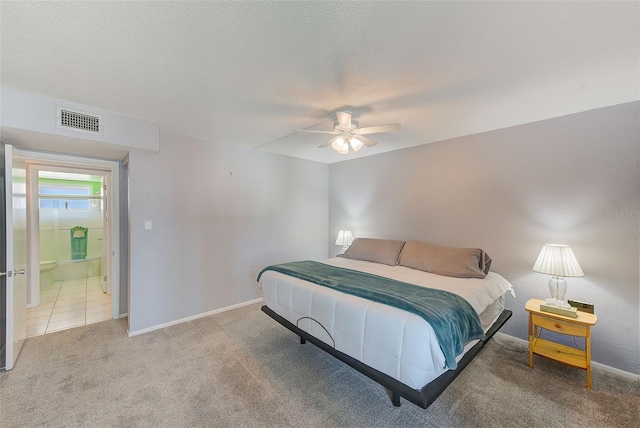 carpeted bedroom with visible vents, ceiling fan, a textured ceiling, and baseboards