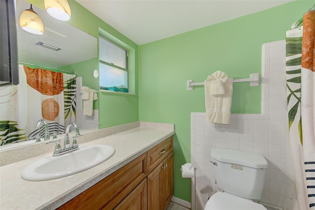 full bathroom featuring visible vents, toilet, tile walls, and vanity