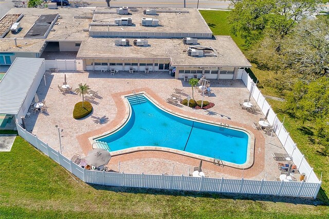 community pool featuring a yard, a patio, and a fenced backyard