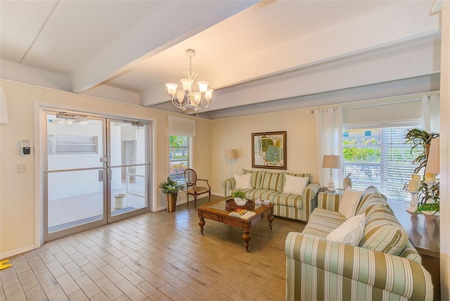 living area featuring a wealth of natural light, beamed ceiling, a chandelier, and light wood finished floors