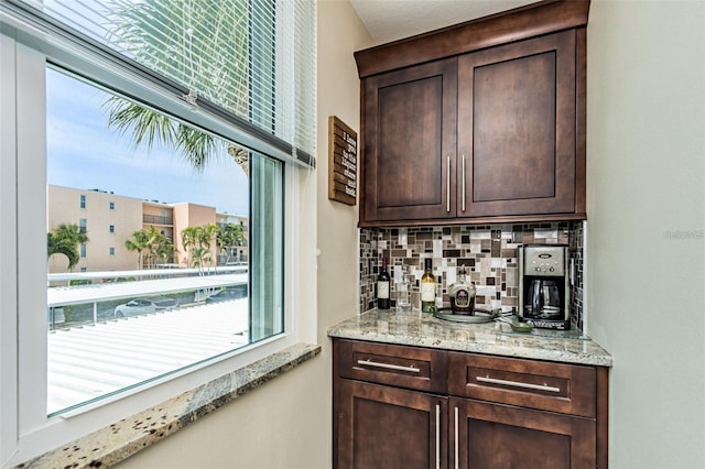 bar featuring decorative backsplash and a bar