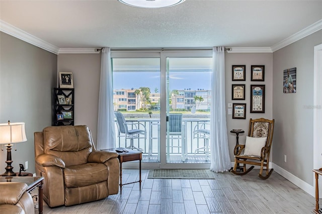 living area with baseboards, crown molding, wood finish floors, and expansive windows