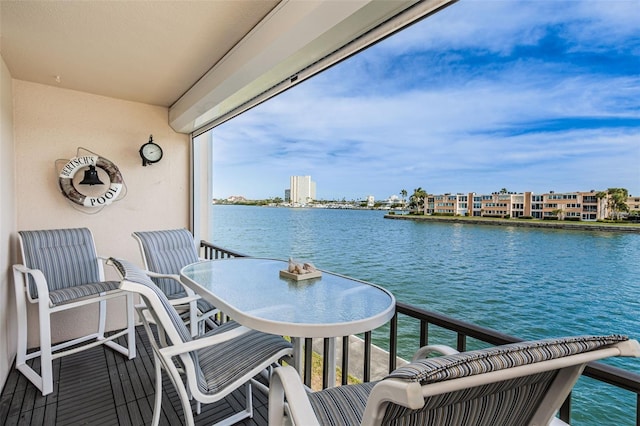 balcony featuring a city view and a water view