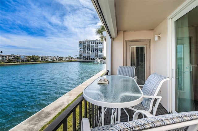 balcony featuring a city view and a water view