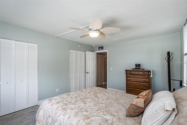 bedroom featuring visible vents, baseboards, and a textured ceiling