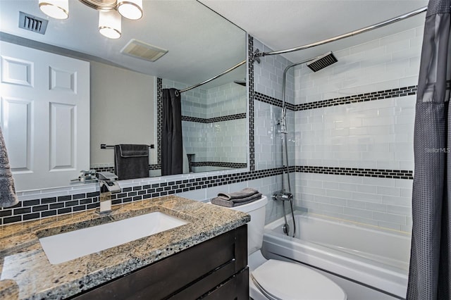 bathroom featuring decorative backsplash, vanity, visible vents, and shower / bathtub combination with curtain