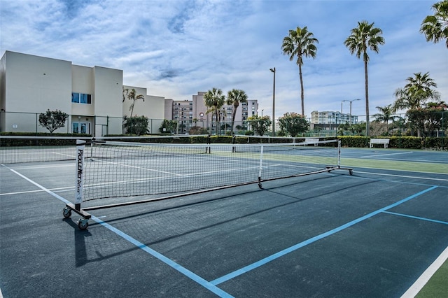 view of tennis court featuring fence