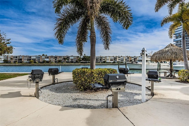 view of patio featuring a water view and a grill