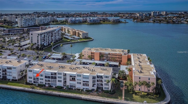 birds eye view of property featuring a city view and a water view