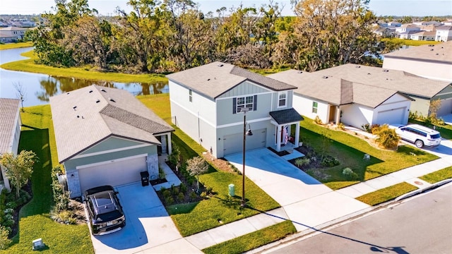 birds eye view of property with a residential view and a water view