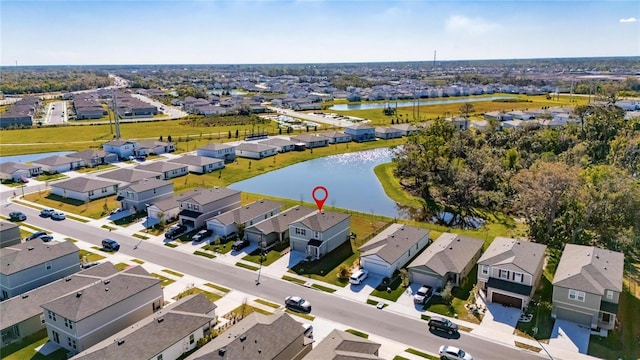 drone / aerial view featuring a residential view and a water view