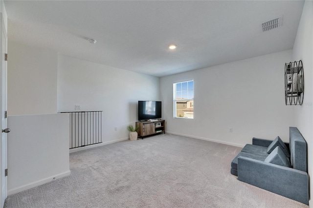 living room with visible vents, carpet floors, and baseboards