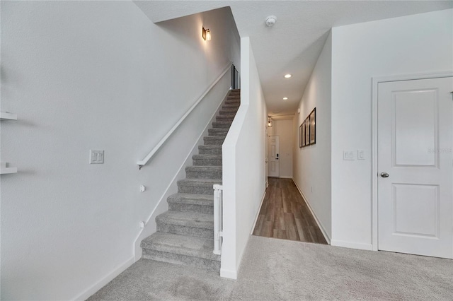 staircase featuring recessed lighting, baseboards, and carpet floors