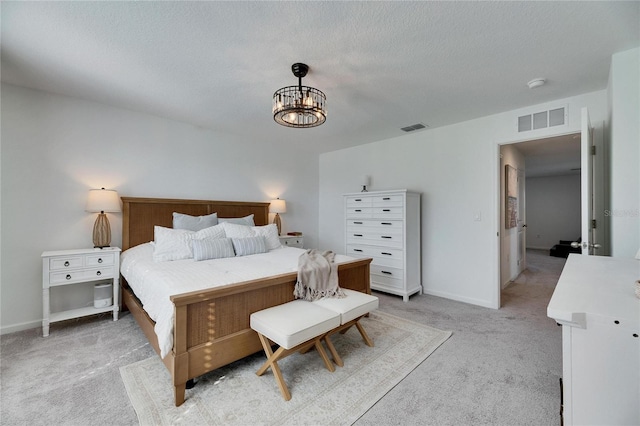 bedroom featuring a notable chandelier, visible vents, light colored carpet, and baseboards