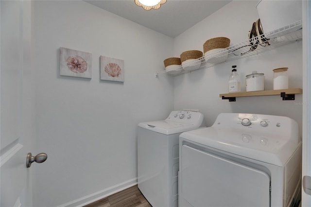 laundry room featuring laundry area, wood finished floors, separate washer and dryer, and baseboards