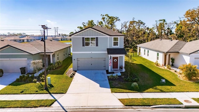 traditional-style home with a residential view, an attached garage, concrete driveway, and a front lawn