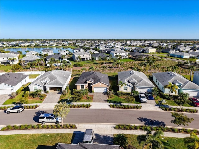 drone / aerial view featuring a residential view and a water view