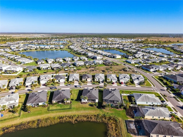 bird's eye view with a residential view and a water view