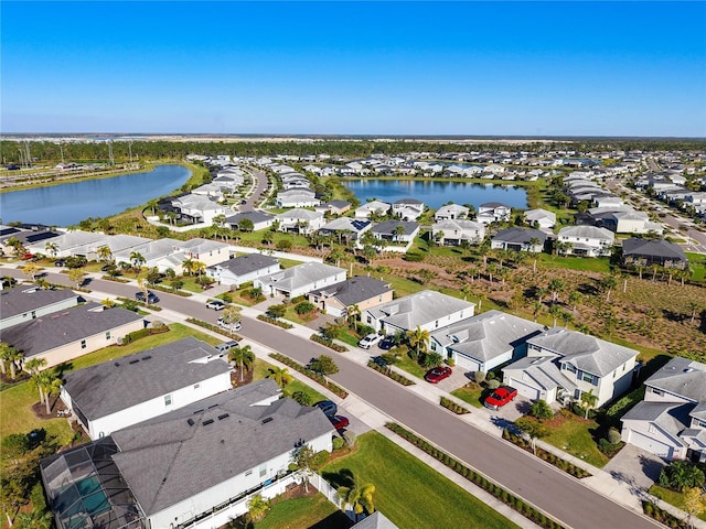 bird's eye view with a residential view and a water view