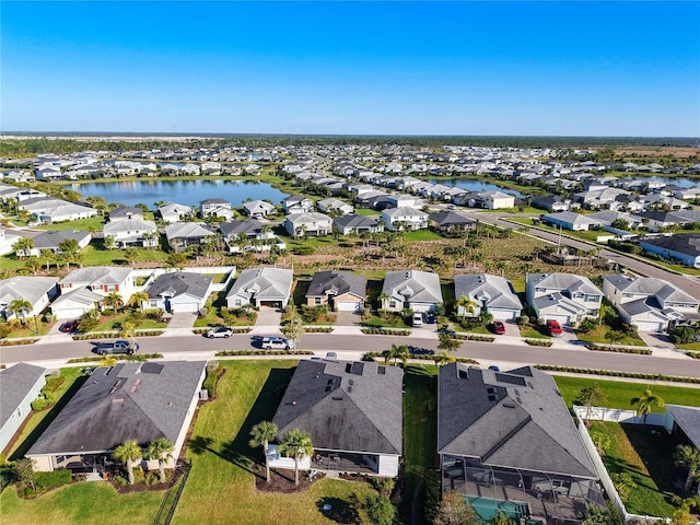 bird's eye view featuring a residential view and a water view