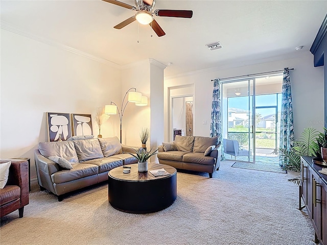 living room with crown molding, light colored carpet, visible vents, and ceiling fan