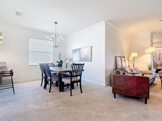 carpeted dining space featuring crown molding, baseboards, visible vents, and a chandelier