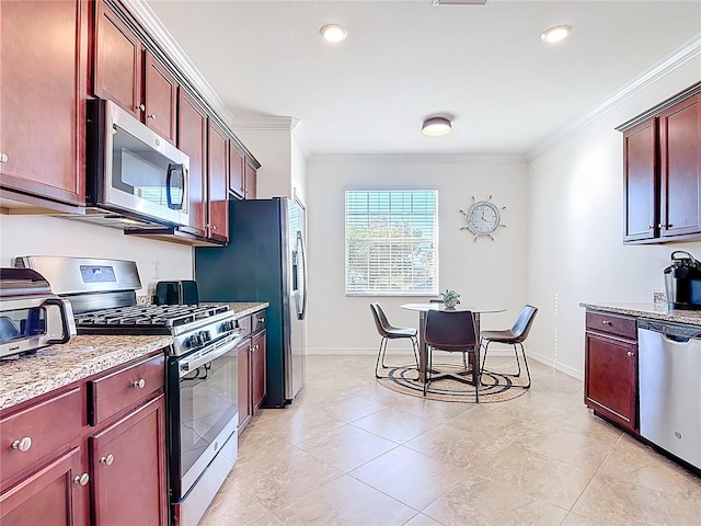 kitchen with stainless steel appliances, reddish brown cabinets, baseboards, and crown molding