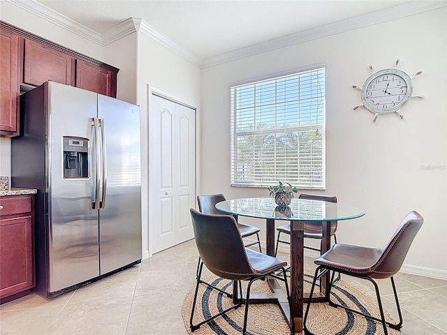 dining area with crown molding, light tile patterned floors, and baseboards