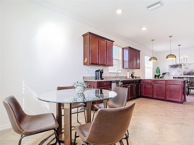 kitchen featuring a peninsula, visible vents, reddish brown cabinets, and ornamental molding