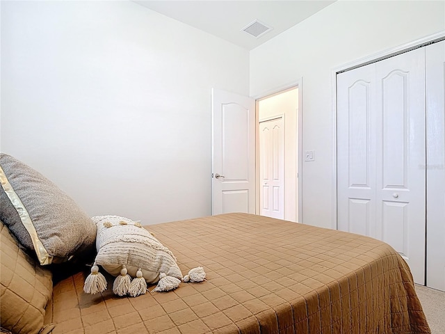 bedroom with visible vents and a closet