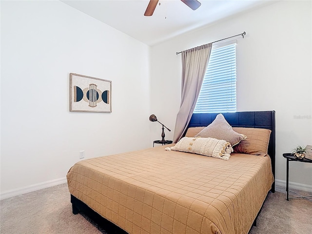 carpeted bedroom featuring baseboards and a ceiling fan