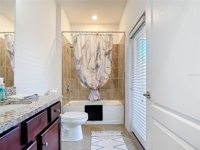 full bath featuring tile patterned flooring, vanity, toilet, and shower / tub combo