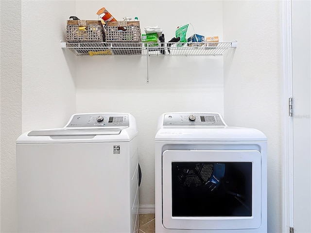 clothes washing area with laundry area and washer and dryer