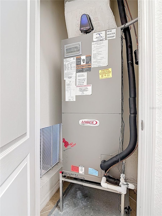 utility room featuring heating unit