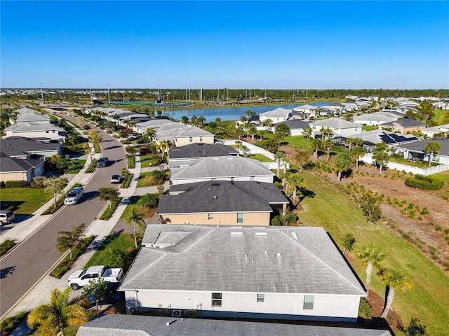 drone / aerial view with a residential view and a water view