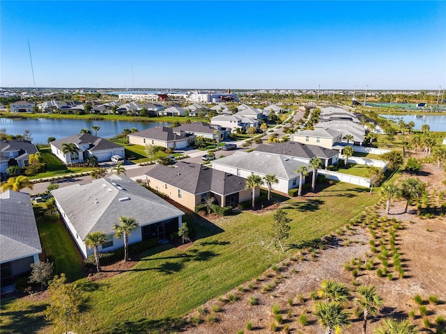 drone / aerial view with a residential view and a water view